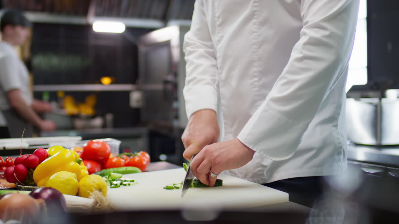 Chef Cutting Cucumber in Restaurant Kitchen