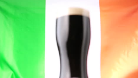 pint of stout against irish flag