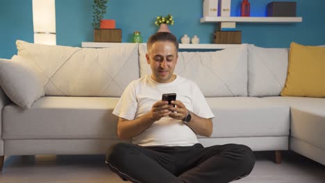 Man-texting-with-happy-expression-with-his-girlfriend.