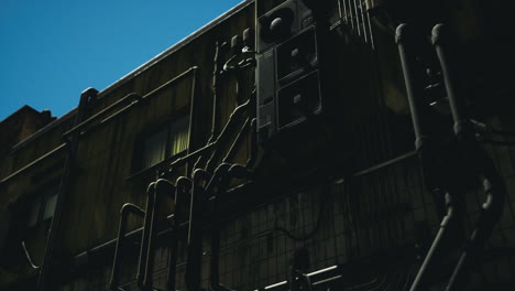 urban exploration of industrial building from low angle under clear sky