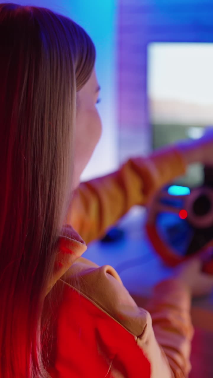 Woman playing race game. Beautiful gamer girl playing video games. Vertical video