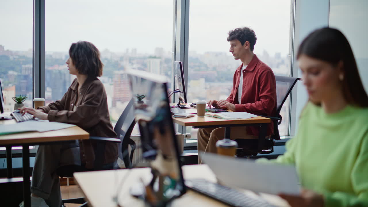 Young creative specialists working developing strategies in modern bright agency