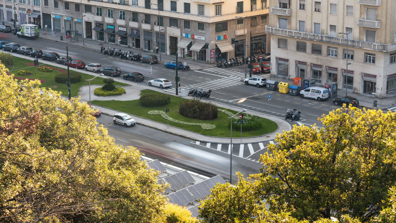 Time-lapse of moving cars on city in Italy with old architecture, trees and shops, urban hyperlapse of street life and transport during golden hour