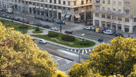 Time-lapse of moving cars on city in Italy with old architecture, trees and shops, urban hyperlapse of street life and transport during golden hour