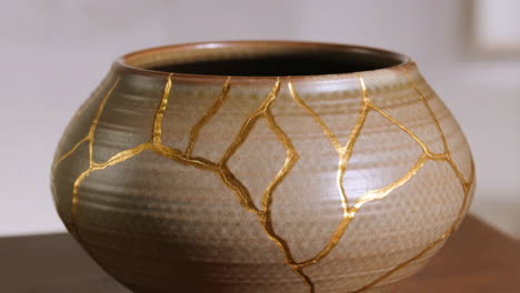 close-up of a kintsugi ceramic bowl with gold crack repair