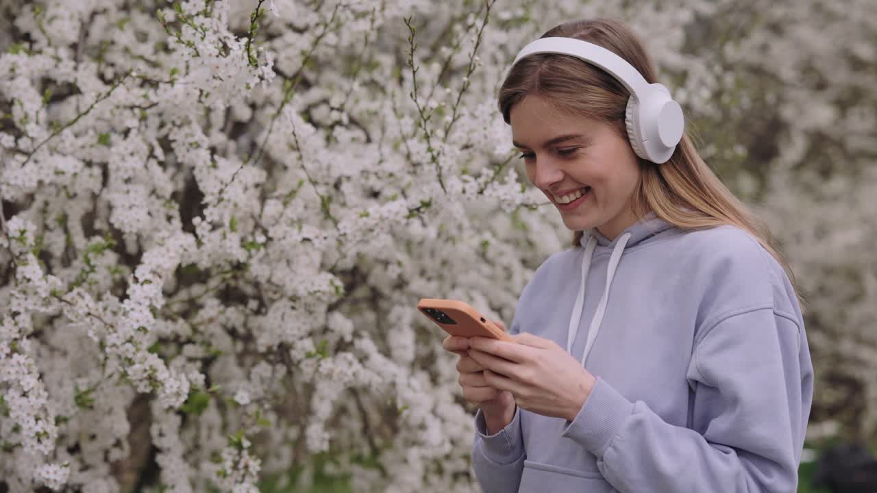 Woman listening to music in a spring park