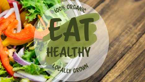 animation of eat healthy locally grown text in green, over bowl of fresh salad on wooden boards