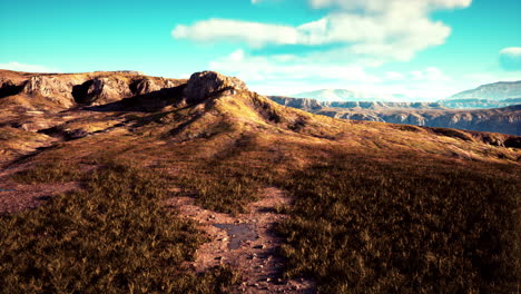 autumn mountain valley against blue cloudy sky