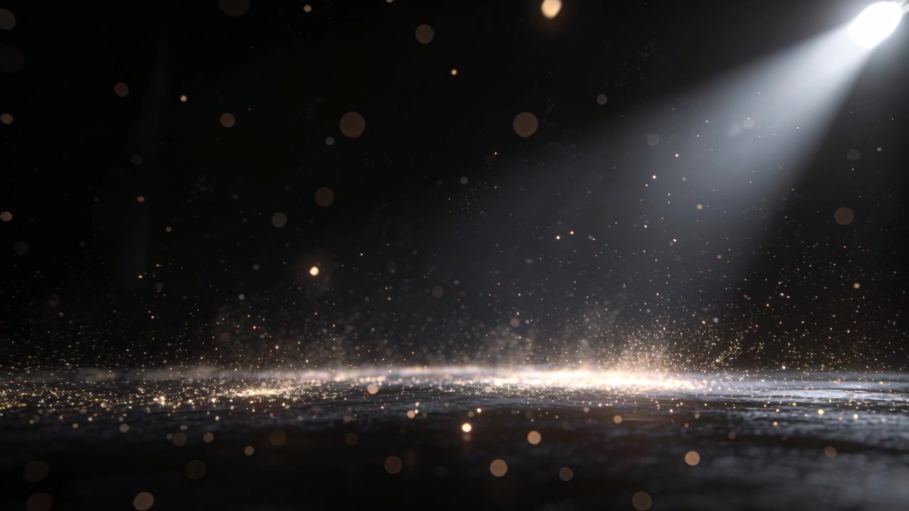 Faro che si accende in alto a destra rivelando una fascia glitterata sul pavimento del palco, mostrando scintille fluttuanti