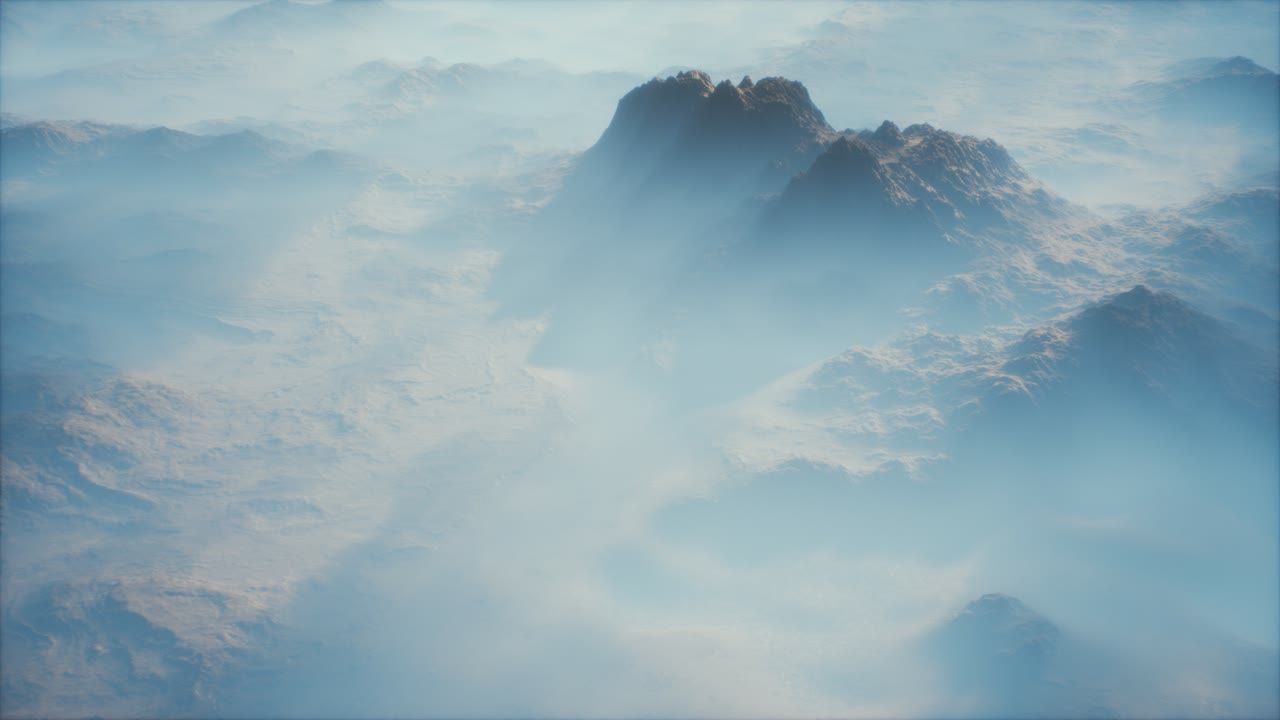 Distant mountain range and thin layer of fog on the valleys