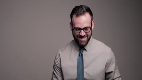 Happy-professional-man-with-beard-talks-and-laughs-at-camera,-medium-shot