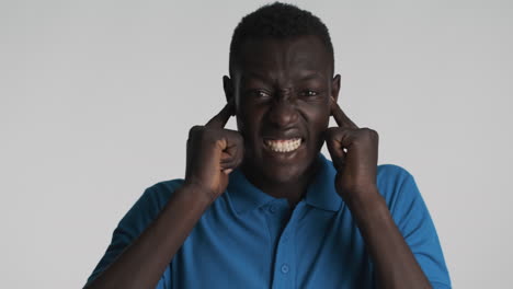 nervous african american man on grey background.