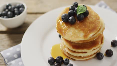 Video-of-pancakes-on-plate-seen-from-above-on-white-background