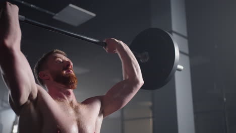 Slow-motion-of-crossfit-athlete-performs-clean-and-jerk.-Young-man-doing-the-clean-and-jerk-weightlifting-exercise-at-the-gym.