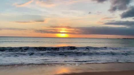 sunset in bali jimbaran beach ocean water waves on shore golden hour