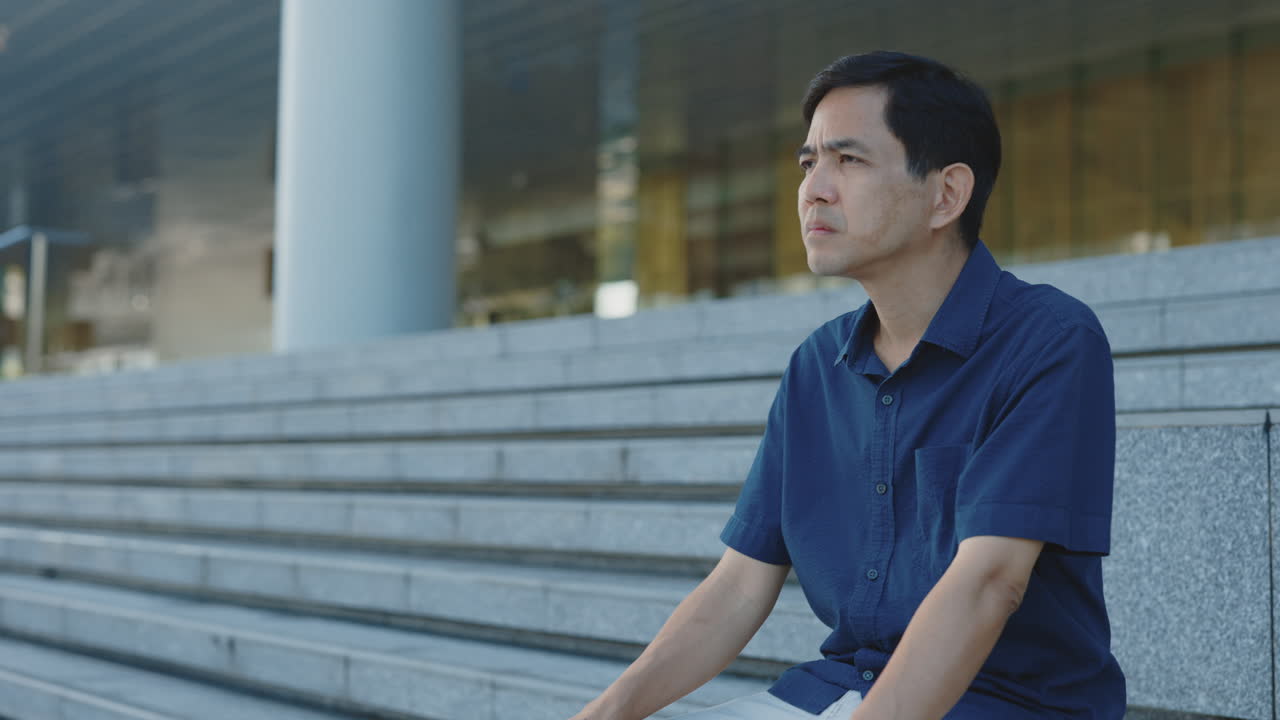 Thoughtful Man Sitting on Steps