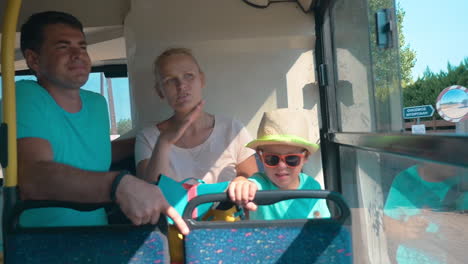 family sitting in a bus