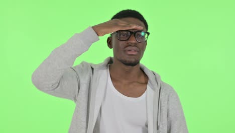 african man looking around, searching green screen