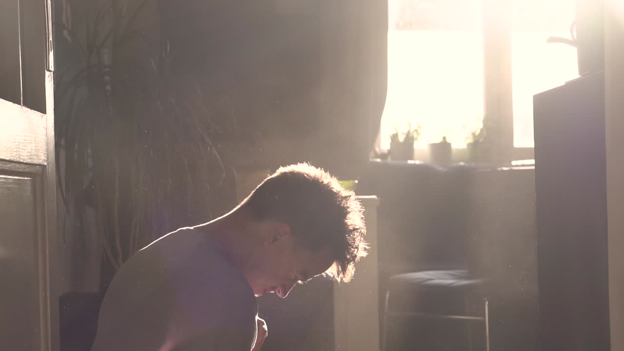 A man coughing in a dusty environment