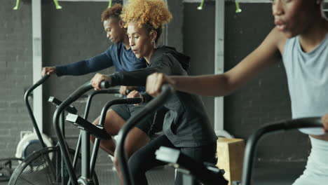 people exercising on exercise bikes in a gym