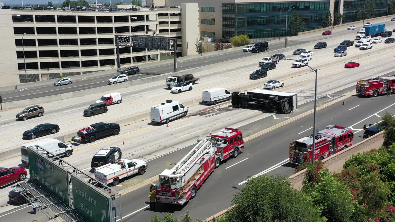 Aerial View of a Major Highway Accident Involving an Overturned Semi-Truck and Emergency Response