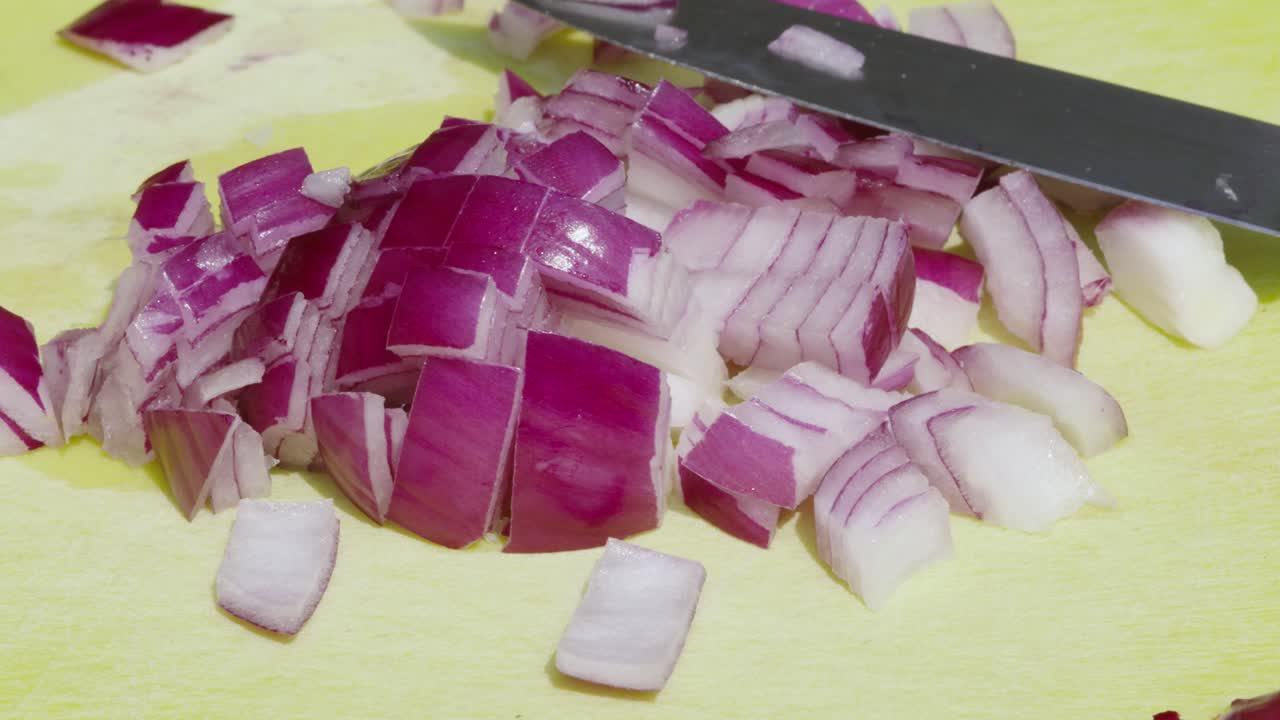 Red Onions Finely Chopped into Small Pieces with Sharp Knife Outdoors in Sunlight - 4K Clip