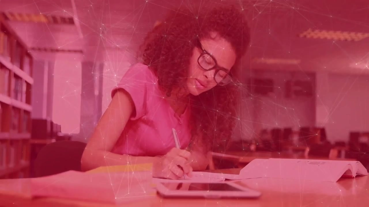 Vertical video: Student writing at table in study, glancing at tablet sparking red overlay for exam