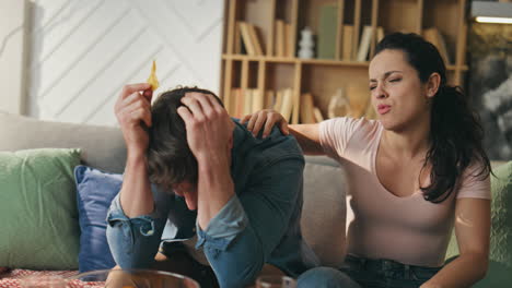 disappointed couple sport fans feeling despair for team lose at home close up.