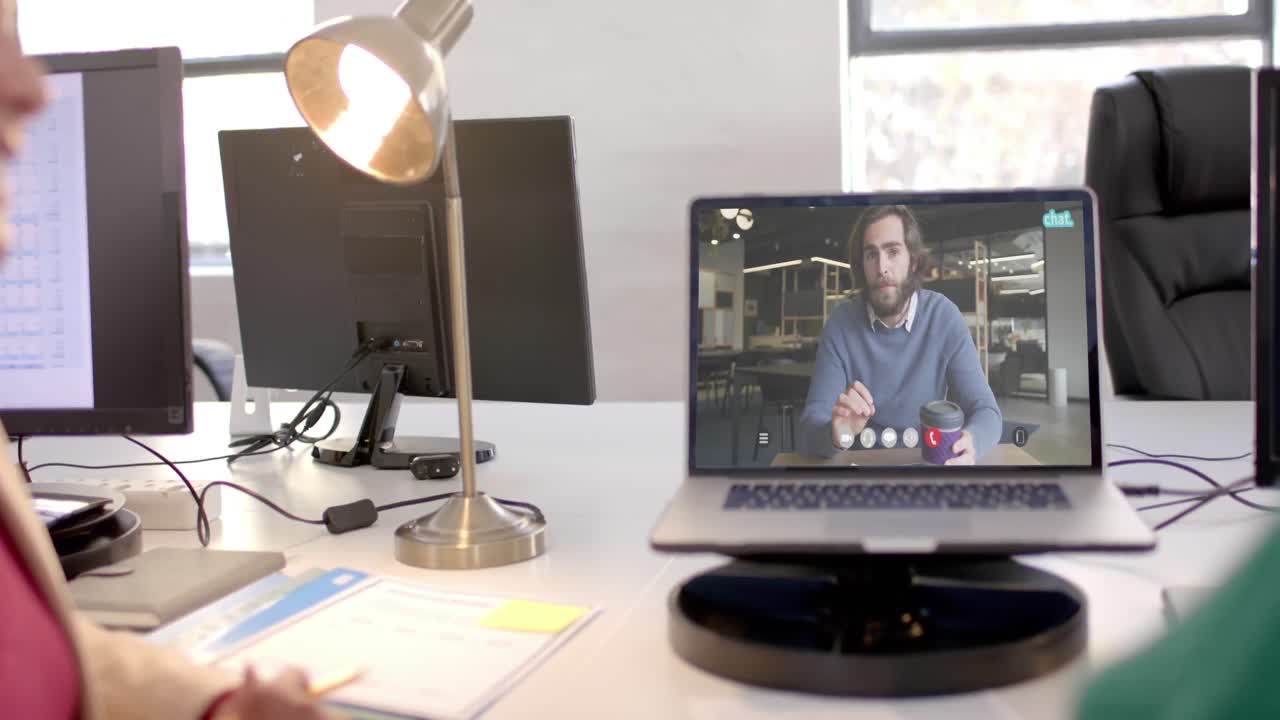 Laptop video call with caucasian male colleague on screen