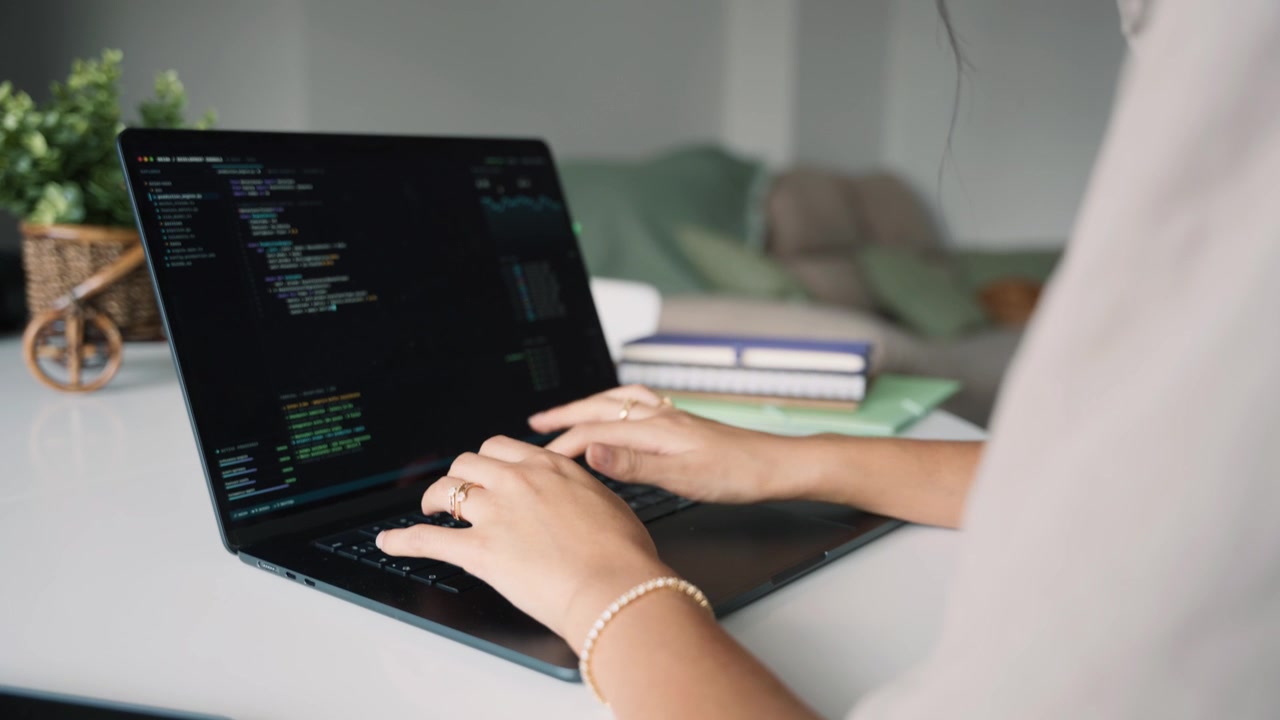 Software Developer Coding on Laptop in Home Office