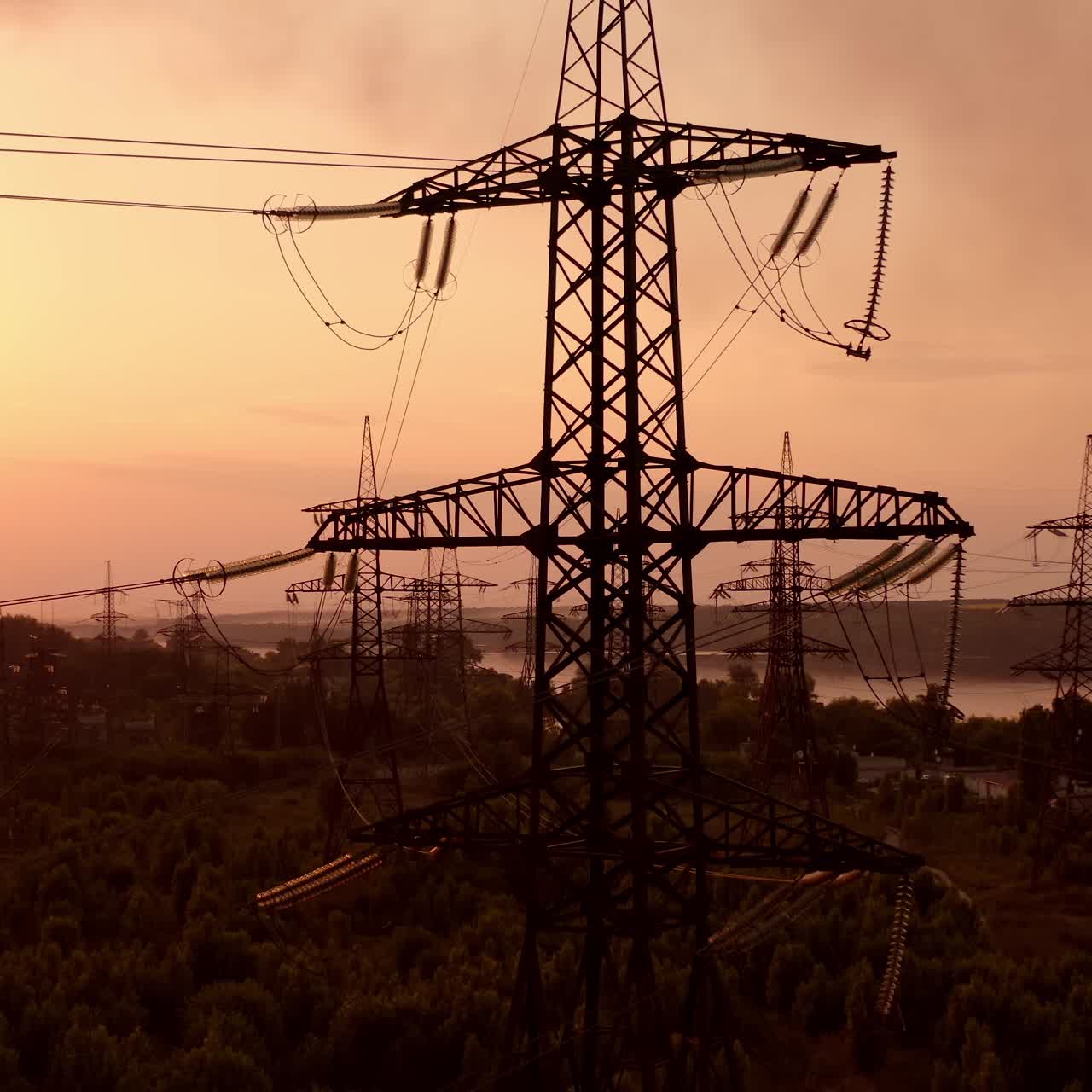 Technogenic landscape, urban. The energy of the pole in the rays of the rising sun. Posts for the transfer of high lead. Steel electric pillars concept