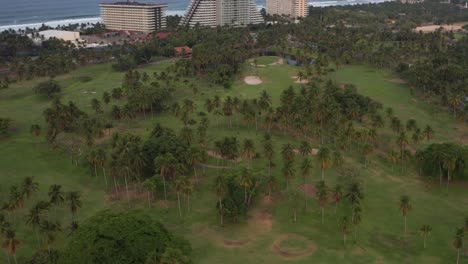 Aerial-View-of-Golf-Field-Meadow-and-Groves-in-Acapulco-Bay-Inland,-Mexico