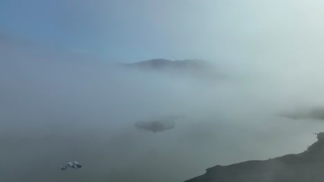 foggy and moody view over sólheimajokull glacier lagoon in south iceland