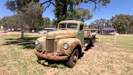 old-fashioned truck stationary in an open grassy area