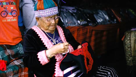 tribal old woman doing embroidery