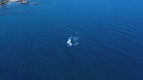 Jet-ski-sailing-at-seascape-in-the-south-coast-of-spain-aerial-drone-view