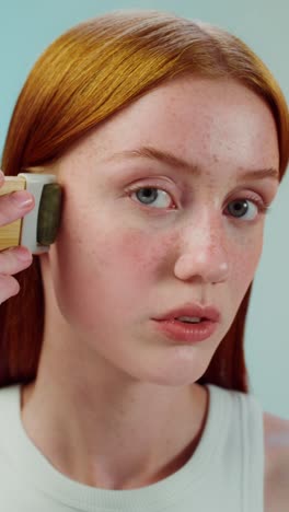 woman using facial roller