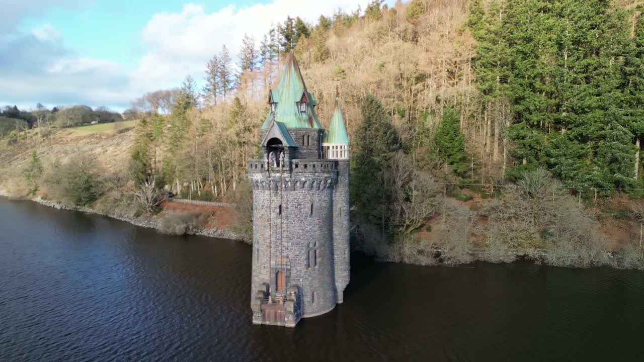 Lake Vyrnwy Straining Tower close in drone anti-clockwise rotate revealing beautiful lake on a crisp, calm, sunny winter afternoon - Wales, UK