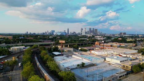 Aerial-footage-of-commercial-buildings-and-transport-infrastructure-in-suburb-at-golden-hour