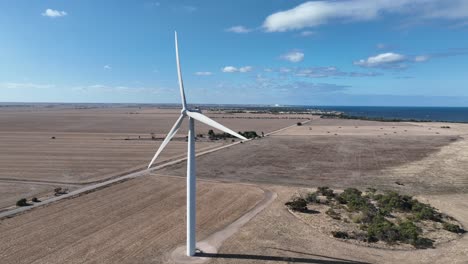 Orbiting-drone-shot-of-spinning-wind-turbine