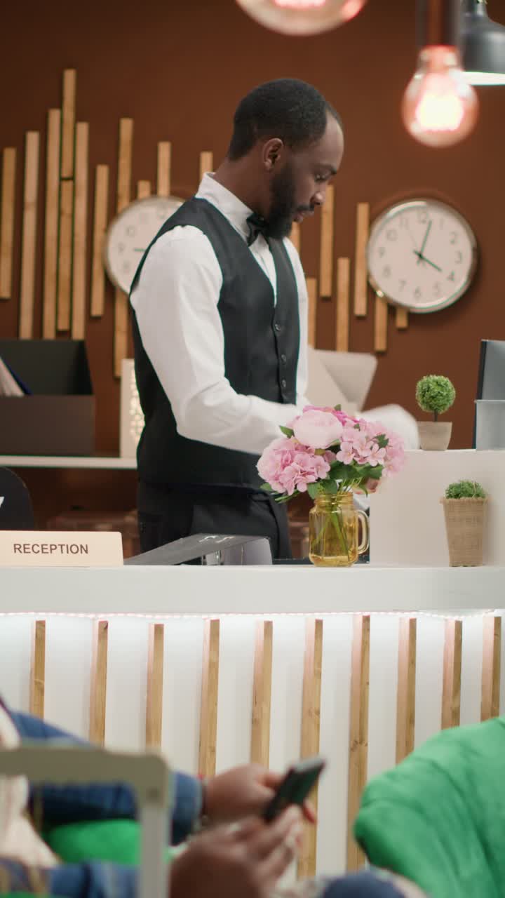 Video verticale: receptionist che esamina i documenti d'identità