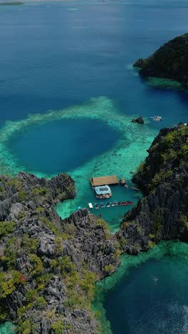 scenic vertical drone shot over limestone islands and clear tropical sea in coron, palawan, philippines – aerial view of coastal paradise