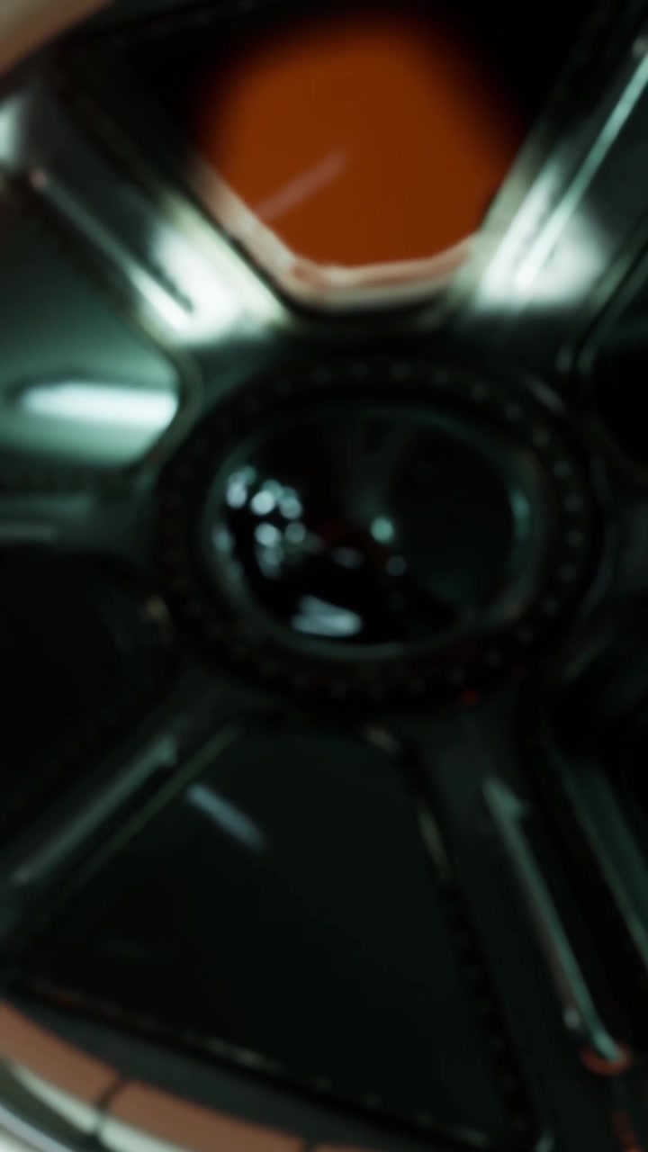 Close view of a circular object with shiny surface and detail in a workspace