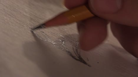 artist sketching up close on a paper