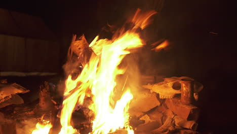 hunter's fire at night, tracking slider shot, deer skulls drying in background