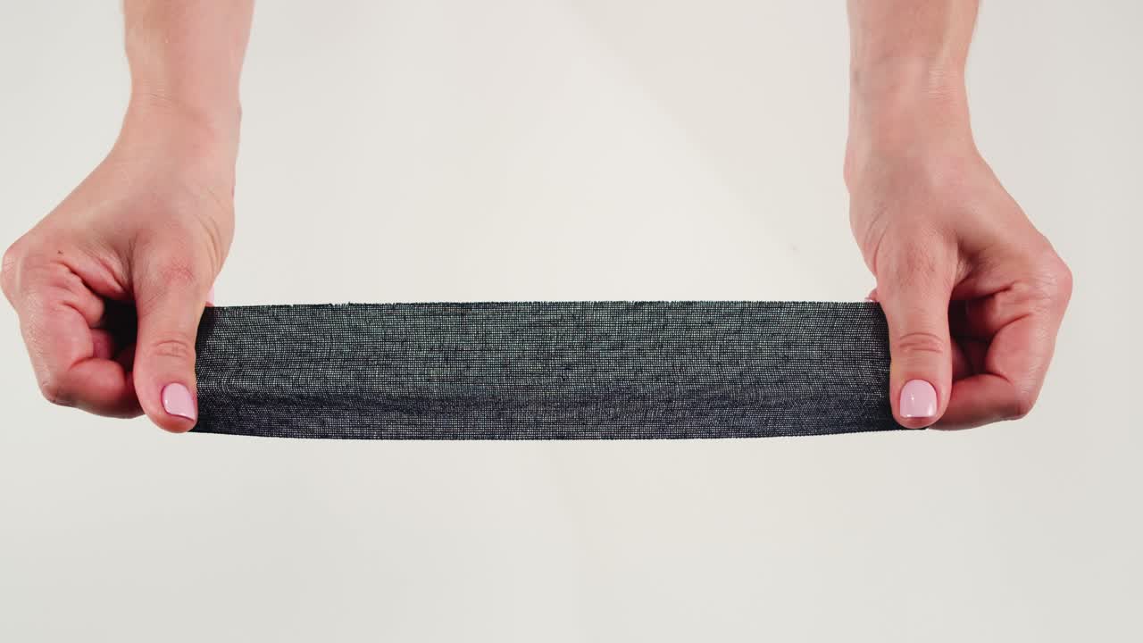 Kinesiology medical taping, doctor Physical therapist applying elastic surgical tape to patient body, treating injured knee young athlete.Post traumatic rehabilitation, sport physical therapy recovery