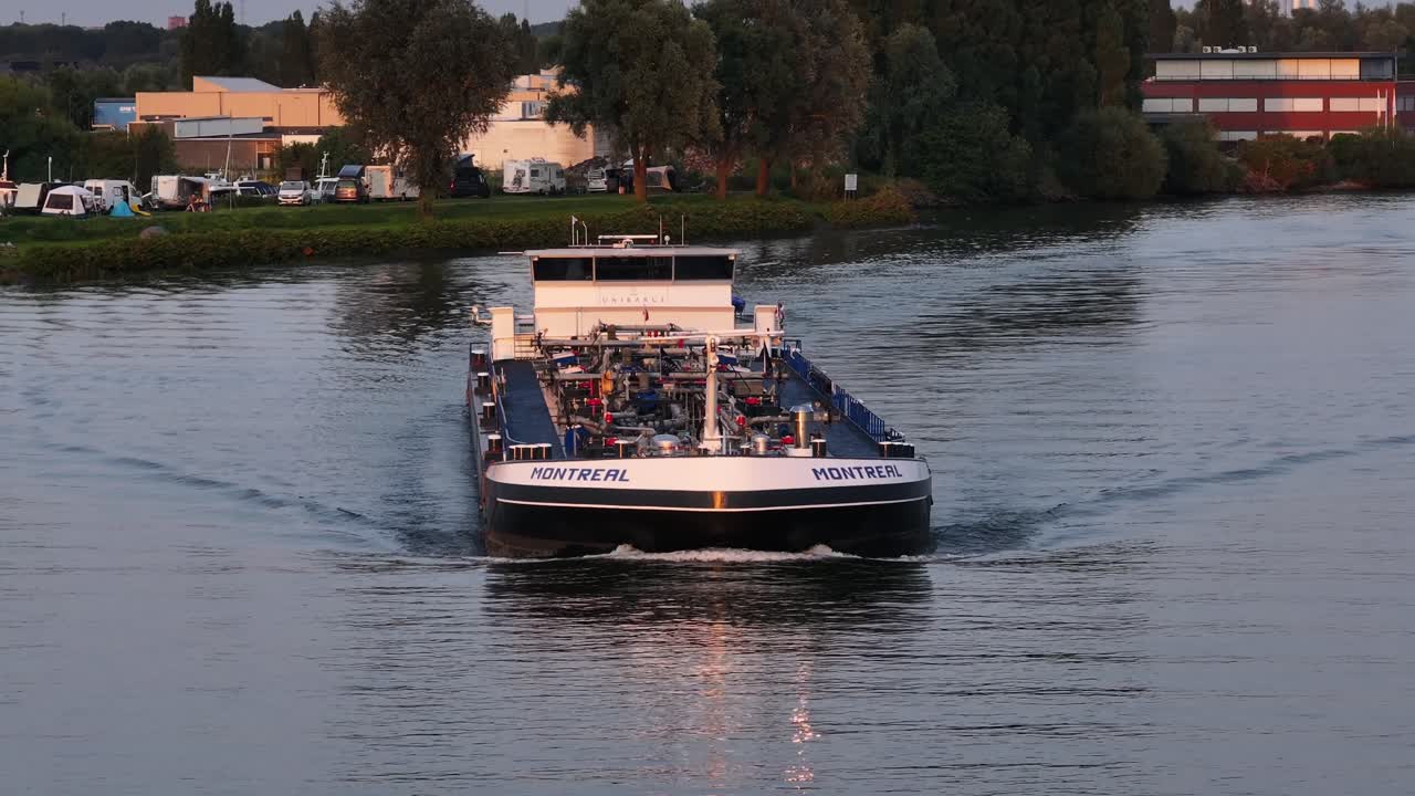 Frontal view of tanker ship Montreal on Dutch river at golden hour