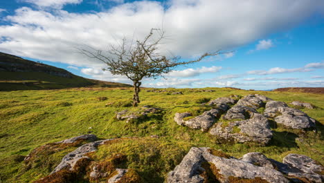 Panorama timelapse of rural nature farmland with field ground rocks in the foreground during cloudy sunny day viewed from Carrowkeel in county Sligo in Ireland