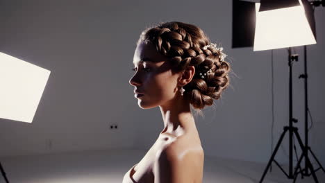studio portrait of a woman with a braided updo