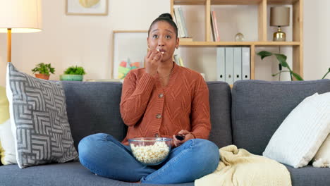 young woman watching an exciting movie alone
